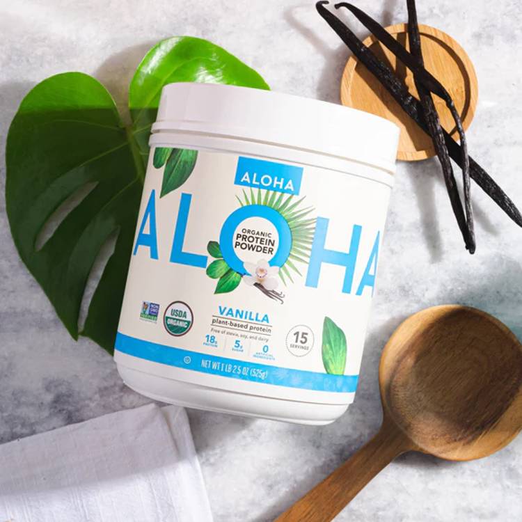 a container of aloha vanilla protein powder next to a wooden spoon a container of aloha vanilla protein powder next to a wooden spoon